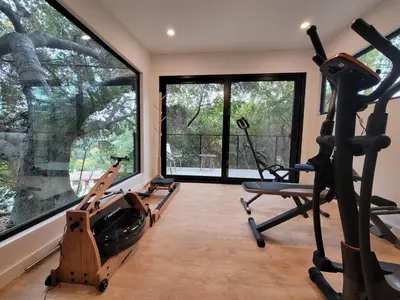 a gym with two treadmills and two exercise bikes at Sumac in Los Angeles
