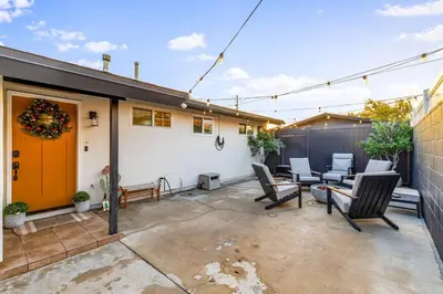 a patio with a bunch of chairs and a house at Modern Anaheim Stay- Minutes to Disney& Family Fun in Anaheim