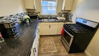 a kitchen with a stove and a sink at LAX House Near SoFi Stadium, Intuit Dome, YouTube Theater, The Kia Forum, Beaches in Inglewood