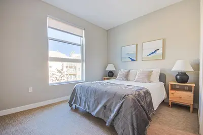 a white bedroom with a bed and a window at Hollywood Escape! Elegant 2BR 2BA Rental in Los Angeles