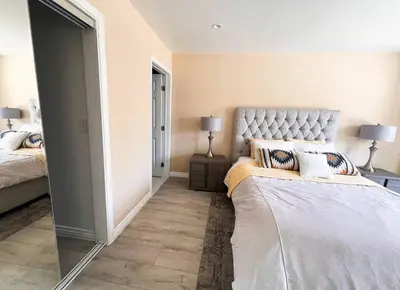 a bedroom with a large bed and a mirror at Luxury Oasis in Central Encino w Pool & Spa Topeka in Los Angeles