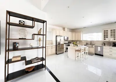 a large white kitchen with a table and a refrigerator at Luxury Oasis in Central Encino w Pool & Spa Topeka in Los Angeles