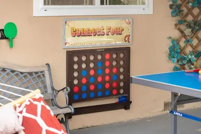 a ping pong table and a ping pong table at Carnival Dream by OC Adventure Homes in Orange