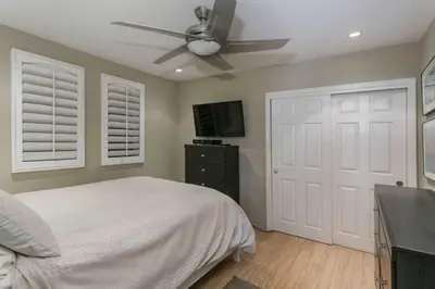 a bedroom with a bed and a ceiling fan at 90210 Beach House Lower Unit in Hermosa Beach