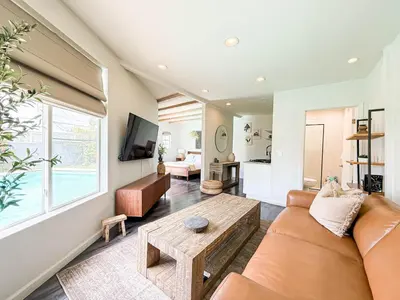 a living room with a couch and a table at Charming Studio Oasis with Pool Near SoFi - MKLAD4 in Los Angeles