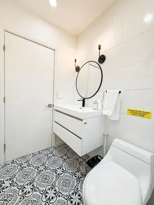 a bathroom with a toilet and a sink and a mirror at Charming Studio Oasis with Pool Near SoFi - MKLAD4 in Los Angeles