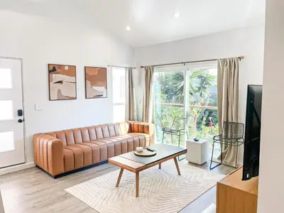 a living room with a couch and a table at Sunny 1BR with Large Outdoor Lounge Space - SH4LAD in Los Angeles