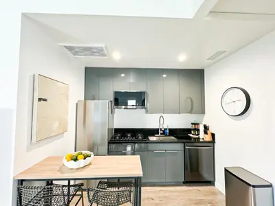 a kitchen with a table with a bowl of fruit on it at Sunny 1BR with Large Outdoor Lounge Space - SH4LAD in Los Angeles