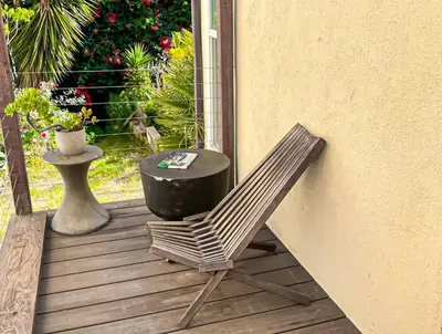 a rocking chair and a table on a porch at Sunny 1BR with Large Outdoor Lounge Space - SH4LAD in Los Angeles