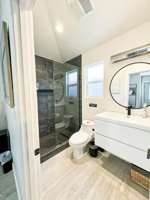 a bathroom with a toilet and a sink and a shower at Charming Poolside ADU Near SoFi Stadium - MK3LAD in Los Angeles