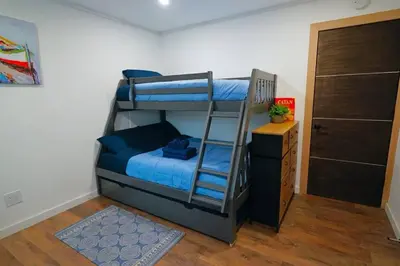 a bedroom with two bunk beds and a closet at Beautiful Renovated Cozy Forest Home with Hot Tub in Crestline in Crestline