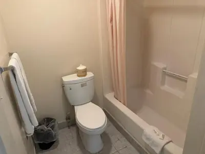 a bathroom with a toilet and a shower and a tub at Best Star Inn - Montebello, Los Angeles in Montebello