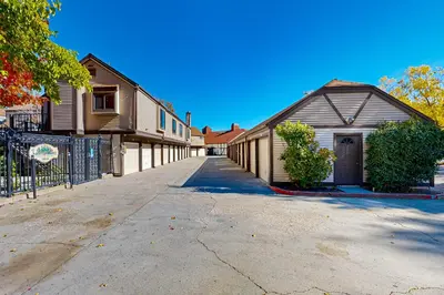 an empty street with a house and a fence at Lake Arrowhead Views! Condo with Shared Pool and Spa in Lake Arrowhead
