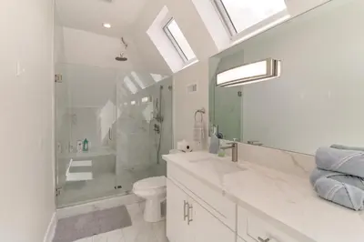 a bathroom with a shower and a toilet and a sink at 1 Mi to Dtwn Pasadena! Newly Built Home in Pasadena