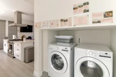 a kitchen with a washer and dryer in a room at 1 Mi to Dtwn Pasadena! Newly Built Home in Pasadena