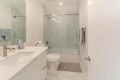 a white bathroom with a sink and a toilet at 1 Mi to Dtwn Pasadena! Newly Built Home in Pasadena