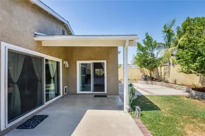 a house with a large glass door in a yard at Charming Bedroom Near Disney Land, Orange County in La Palma