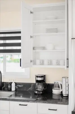 a kitchen with white cabinets and a counter top at Luxurious Newly Remodeled 4 Bedroom Home with Large Backyard near Disneyland in Anaheim