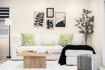 a living room with a white couch and a table at Luxurious Newly Remodeled 4 Bedroom Home with Large Backyard near Disneyland in Anaheim