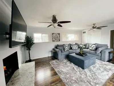 a living room with a couch and a ceiling fan at Lovely home close by SOFI Stadium in Inglewood