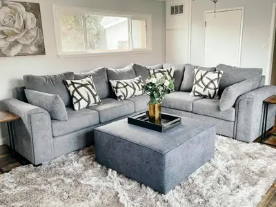a living room with a gray couch and a coffee table at Lovely home close by SOFI Stadium in Inglewood