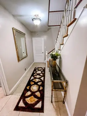 a hallway with a rug on the floor and stairs at Lovely home close by SOFI Stadium in Inglewood
