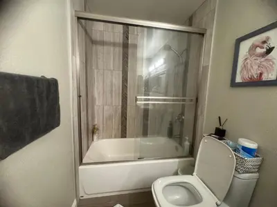 a bathroom with a tub and a toilet and a shower at villa Double Room in Chino Hills