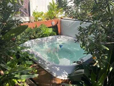 a bath tub in the middle of a garden at 90210 Beach House Middle Unit in Hermosa Beach