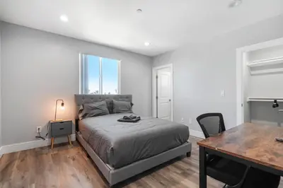 a bedroom with a bed and a desk and a table at Modern Bedroom in Los Angeles