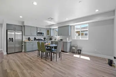 a large kitchen with a table and chairs in it at Modern Bedroom in Los Angeles