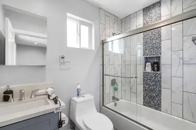 a white bathroom with a toilet and a shower at Modern Bedroom in Los Angeles