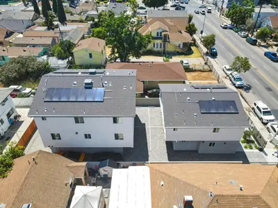 an overhead view of houses with solar panels on their roofs at Modern Bedroom in Los Angeles