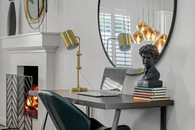 a desk with a bust and a laptop and a mirror at Los Angeles, CA Near Malibu - Pool in Los Angeles