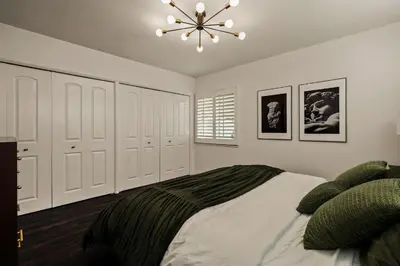 a bedroom with a bed and a chandelier at Los Angeles, CA Near Malibu - Pool in Los Angeles