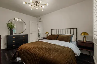 a bedroom with a large bed and a mirror at Los Angeles, CA Near Malibu - Pool in Los Angeles
