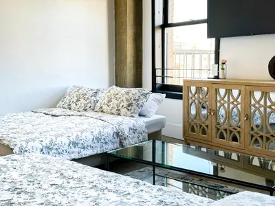 a living room with a couch and a glass table at Urban 1-bedroom Apartment in Los Angeles