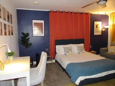 a bedroom with a bed and a desk and a couch at Forest Moon Cottage in Big Bear City Airport