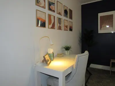 a white desk with a lamp and a chair at Forest Moon Cottage in Big Bear City Airport