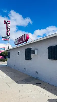 a motel sign on the side of a building at vogue motel in South Gate