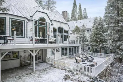 a house with a porch and a deck with a couch at Navigate Stays Best Dressed Lakefront Home in Lake Arrowhead