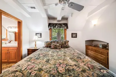 a bedroom with a bed and a ceiling fan at Navigate Stays Best Dressed Lakefront Home in Lake Arrowhead