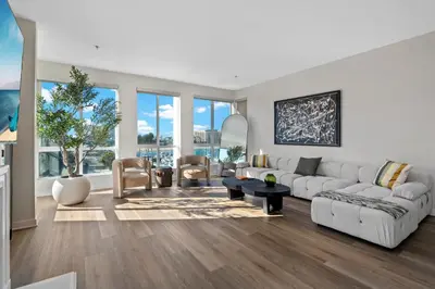 a living room with white furniture and large windows at Coastal Bliss - Luxe 2BR Retreat in MDR - Venice - SM in Los Angeles