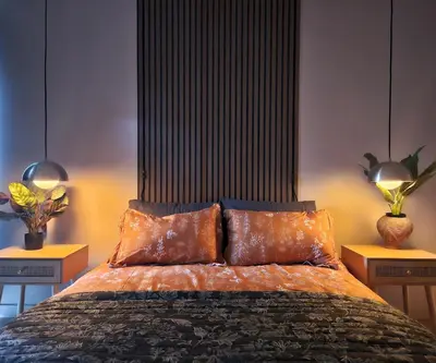 a bedroom with a large bed with two lamps at Brimfield Stay in Los Angeles