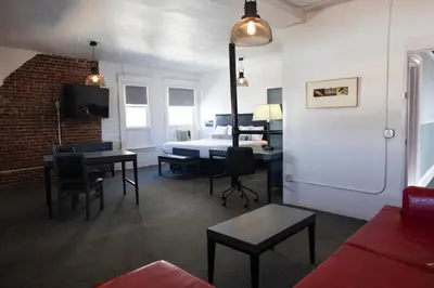 a living room with a bed and a table and chairs at American Hotel in Los Angeles