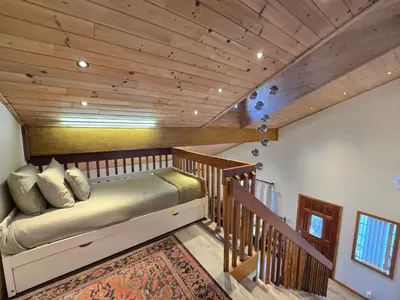 a bedroom with a bed and a wooden ceiling at Modern Lagunita Cabin Near the Lake in Big Bear Lake