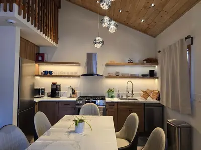 a kitchen with a table and chairs in a room at Modern Lagunita Cabin Near the Lake in Big Bear Lake