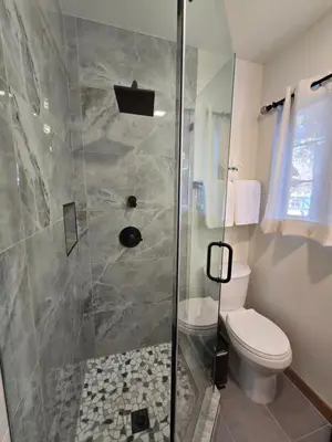 a bathroom with a shower and a toilet at Modern Lagunita Cabin Near the Lake in Big Bear Lake