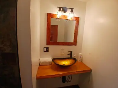 a bathroom with a wooden sink and a mirror at Cabin 33, 3 bedroom 2 bath in Big Bear Lake