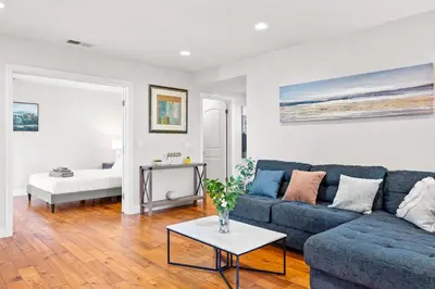 a living room with a blue couch and a table at Luxury Estate with Sparkling Pool & Elegant Amenities in Glendora