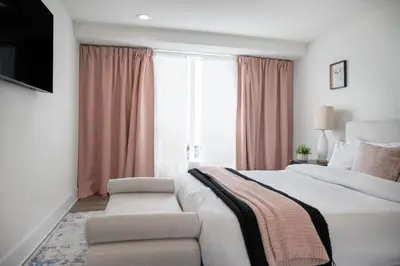 a bedroom with a bed and a couch and a window at 5 Star Private House 5 rooms in Los Angeles